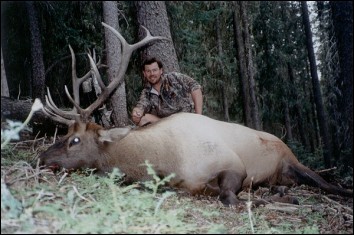 Outfitter/head guide with 6x6 archery Bull Elk.